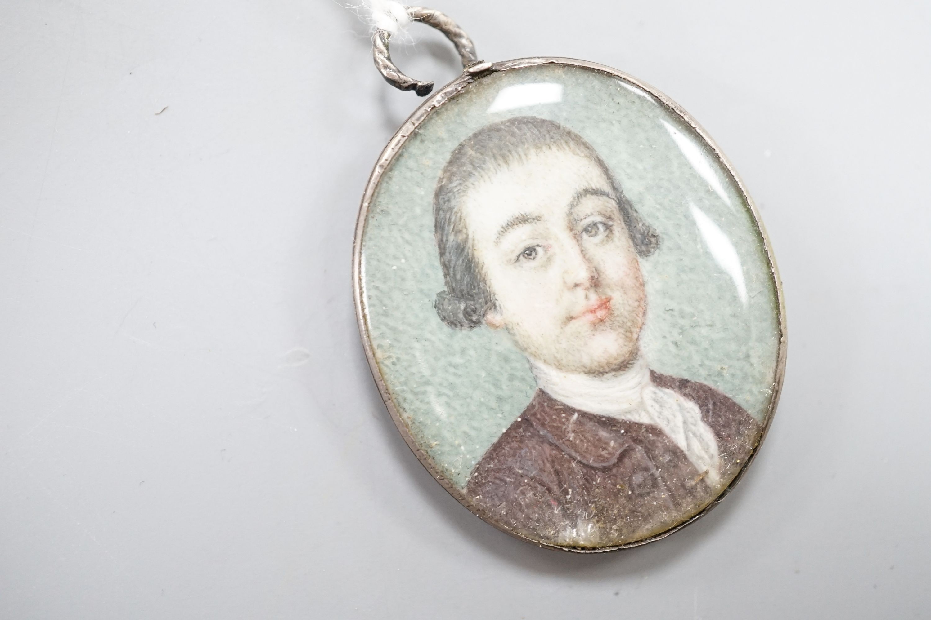 Late 18th century English School, oil on ivory, Miniature portrait of a gentleman in a brown coat 3.5x3cm